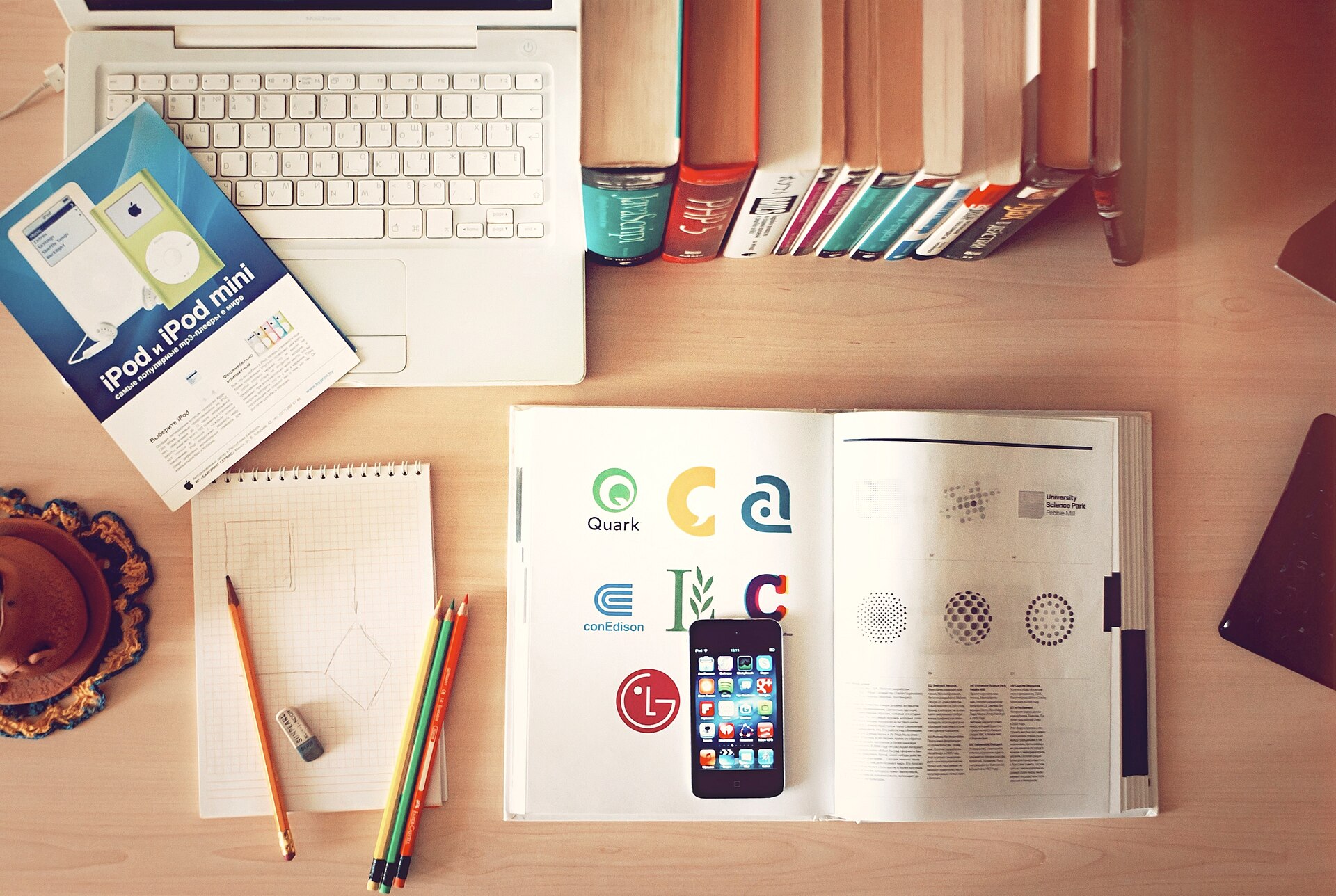 A desk with a laptop, notebook and documents before a signing session